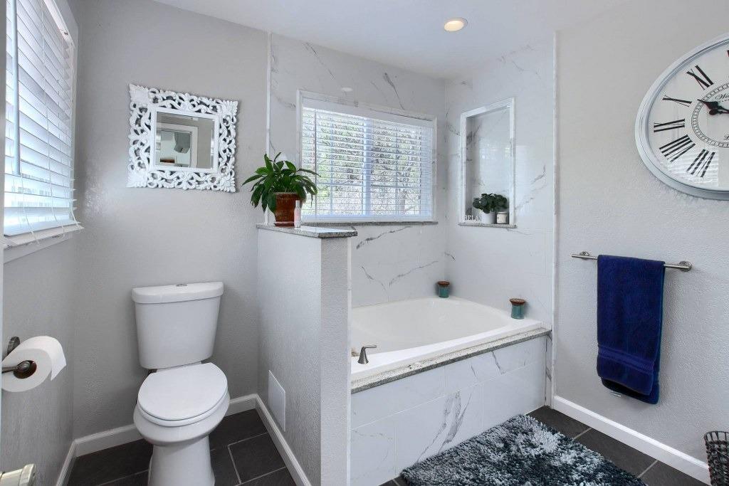 50537 Cedar Valley Drive Oakhurst, CA 93644 - Photo 34 of 59 a white toilet sitting next to a bathroom sink and tub