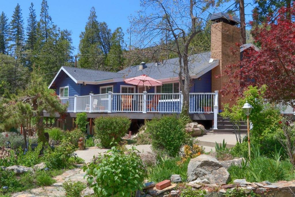 50537 Cedar Valley Drive Oakhurst, CA 93644 - Photo 36 of 59 a front view of a house with a yard and trees