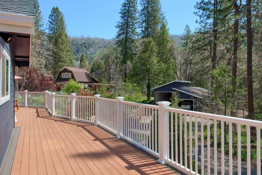 50537 Cedar Valley Drive Oakhurst, CA 93644 - Photo 39 of 59 a view of a wooden deck and trees with wooden fence