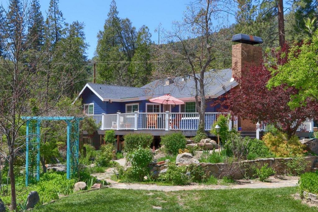 50537 Cedar Valley Drive Oakhurst, CA 93644 - Photo 43 of 59 a front view of a house with garden