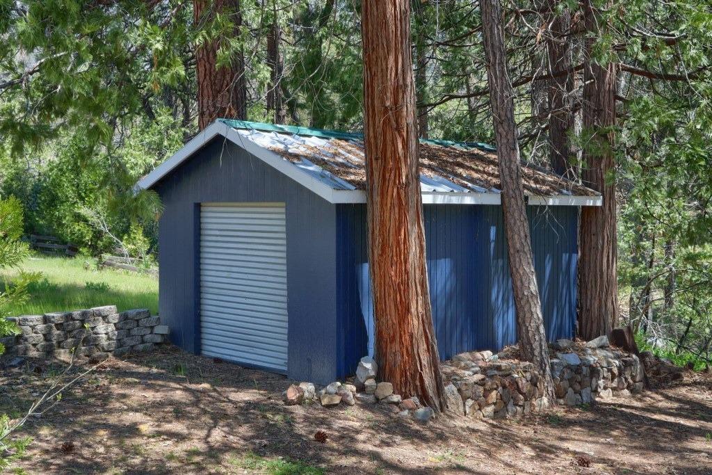 50537 Cedar Valley Drive Oakhurst, CA 93644 - Photo 54 of 59 a view of a house with a tree in the yard