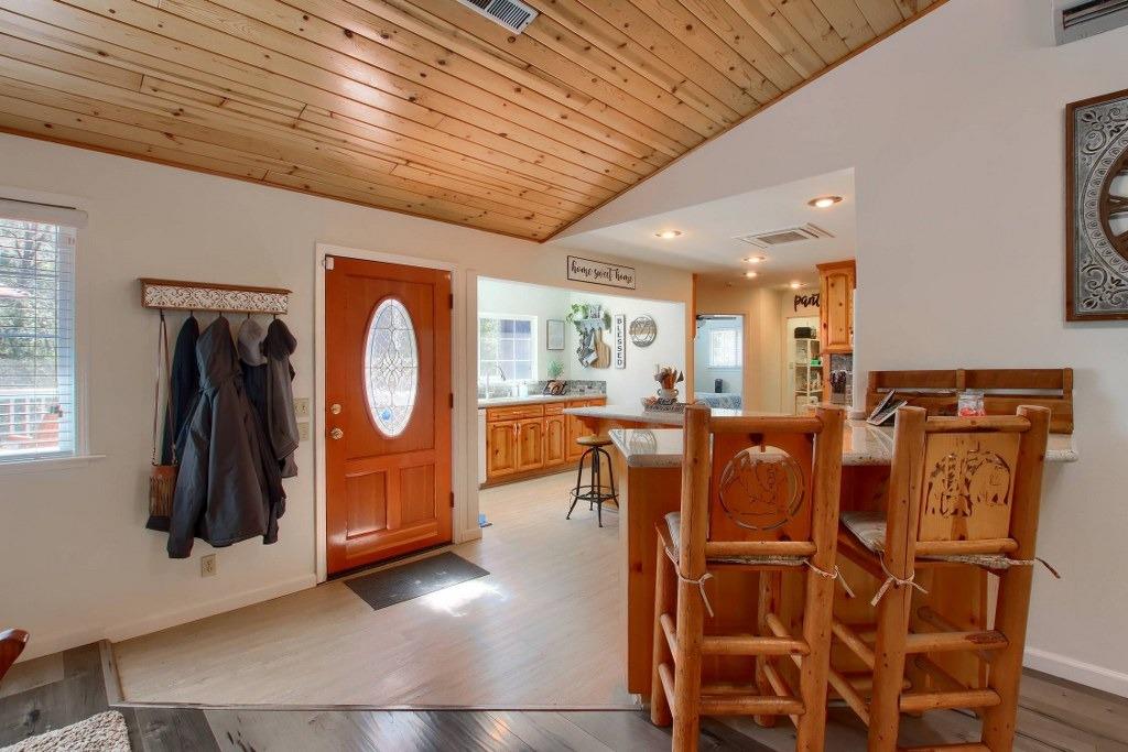 50537 Cedar Valley Drive Oakhurst, CA 93644 - Photo 7 of 59 a living room with furniture a flat screen tv and floor to ceiling window