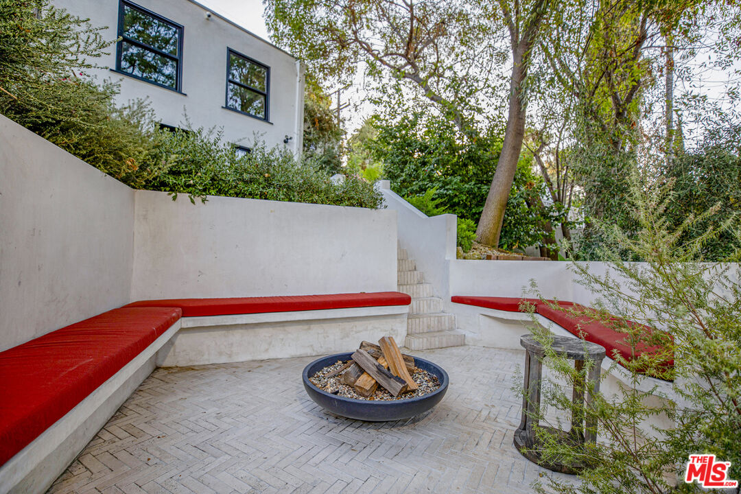1411 Wellesley Drive Glendale, CA 91205 - Photo 28 of 32 a backyard view with table and chair plants and large trees