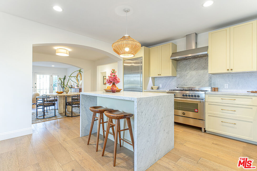 1411 Wellesley Drive Glendale, CA 91205 - Photo 9 of 32 a kitchen with stainless steel appliances a stove a sink dishwasher and cabinets with wooden floor