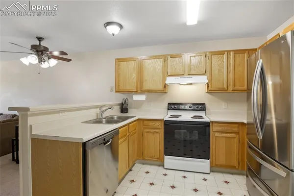 a kitchen with a stove cabinets and refrigerator