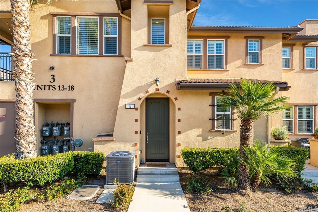 16001 Chase Road, Unit 13 Fontana, CA 92336 - Photo 1 of 1 a front view of a house with garden