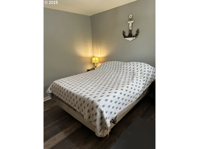 a bed sitting in a bedroom next to a window