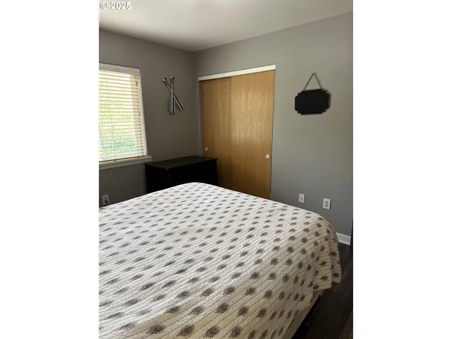 a bedroom with a bed and cabinets