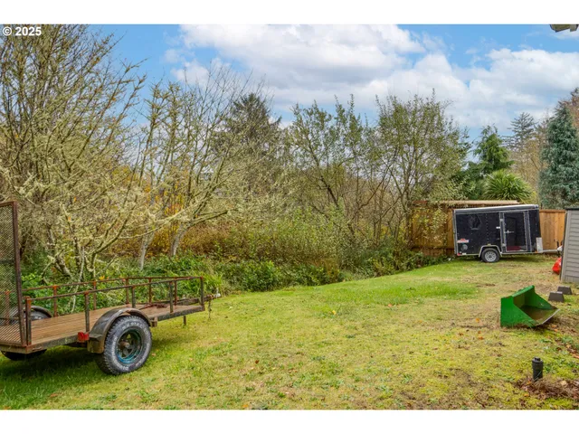 a view of a backyard with wooden fence