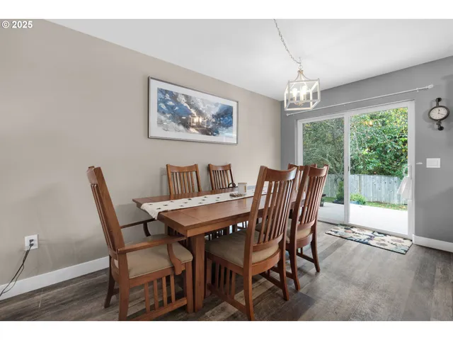 a view of a dining room with furniture a chandelier and wooden floor