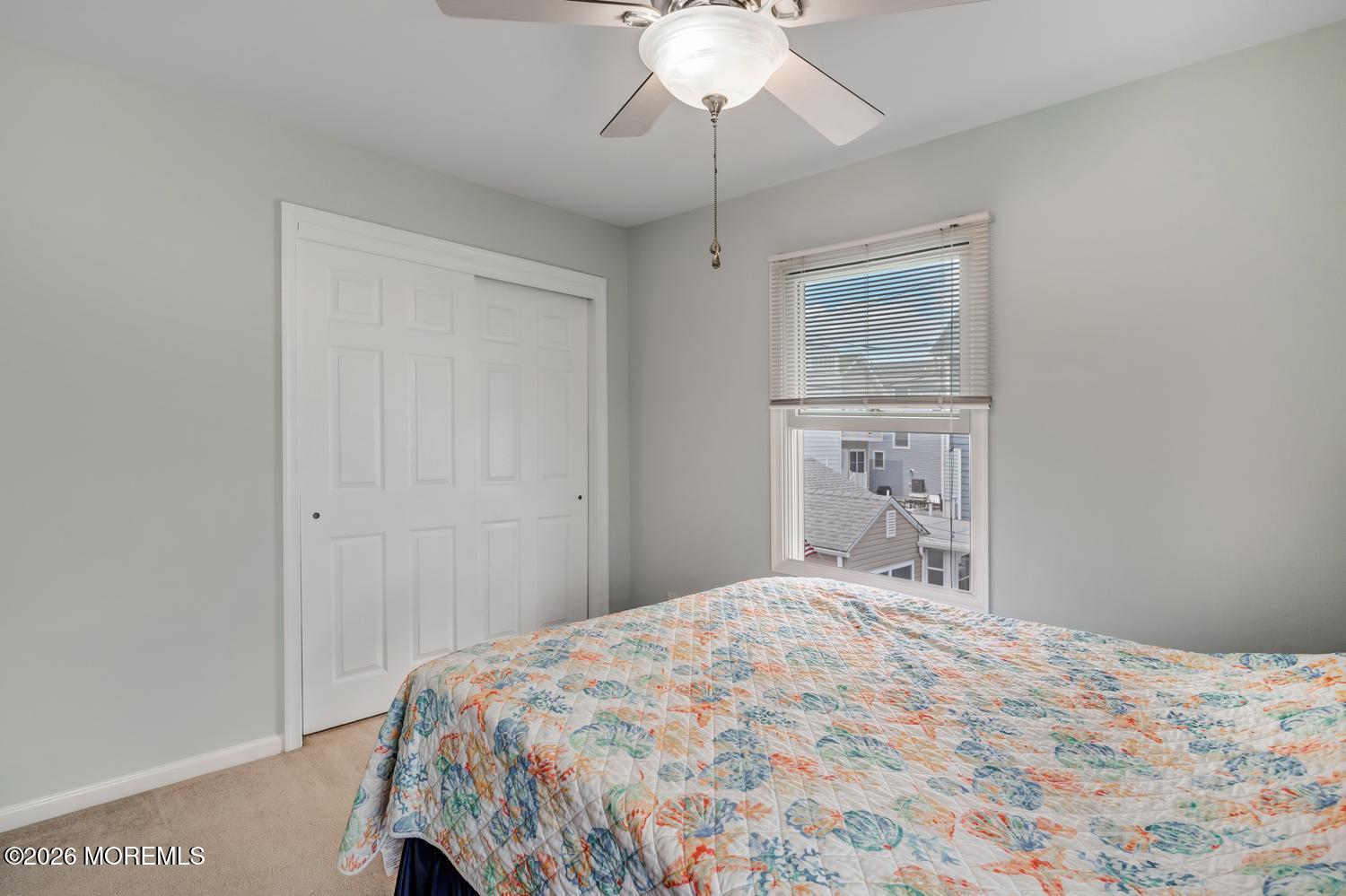 19 Shore Way Lavallette, NJ 08735 - Photo 21 of 38 a bedroom with a bed and a chandelier