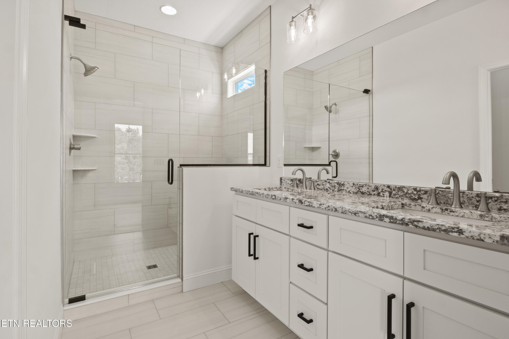 310 Pocahontas Lane Rutledge, TN 37861 - Photo 24 of 49 a bathroom with a granite countertop sink two mirror and shower