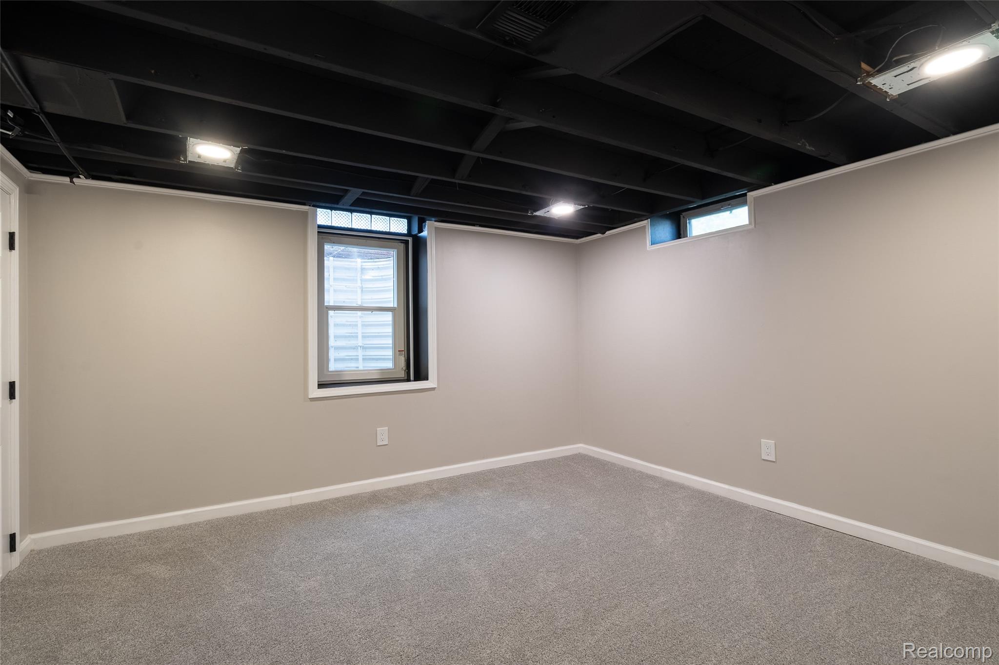 201 Cardwell Street Inkster, MI 48141 - Photo 33 of 41 Finished room featuring gray carpeting, neutral-toned walls, and a painted black exposed joist ceiling