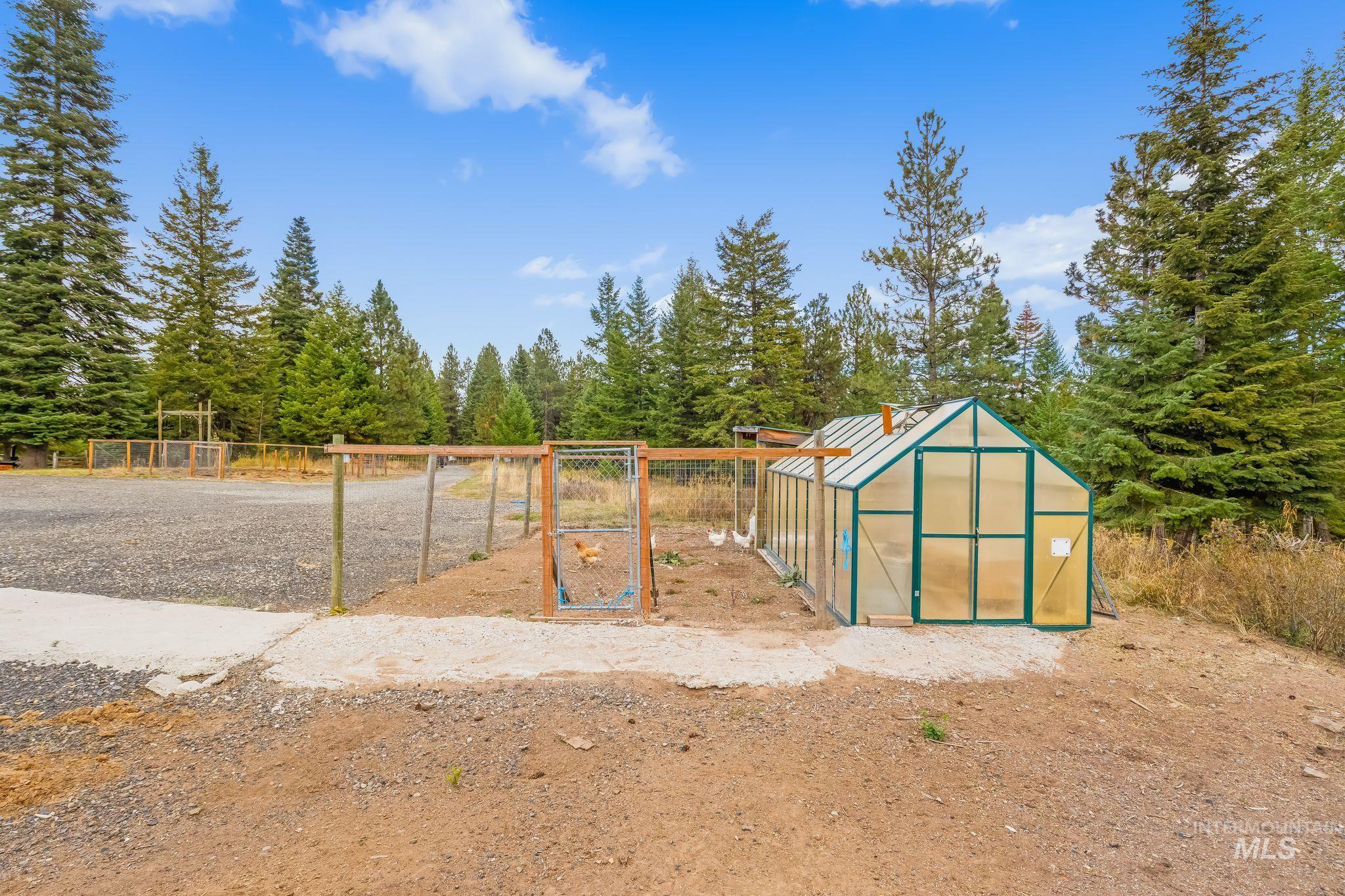 3989 East Mountain Road Anatone, WA 99401 - Photo 27 of 49 Freestanding greenhouse with a metal frame and translucent panels