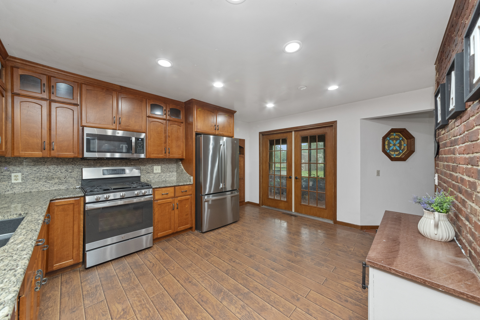 23949 West McClintock Road Channahon, IL 60410 - Photo 5 of 21 a kitchen with stainless steel appliances granite countertop a stove a sink and a refrigerator with wooden floor