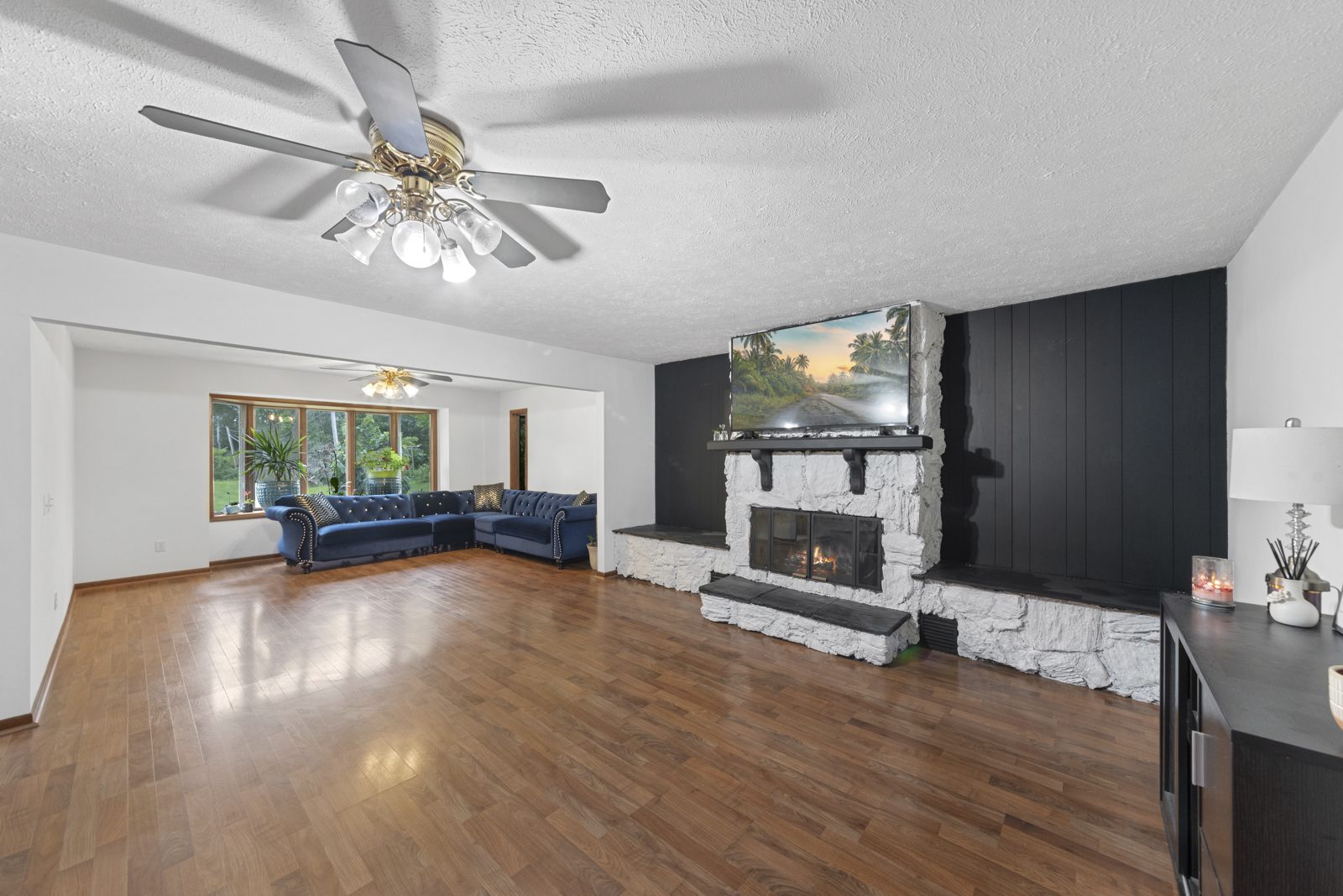 23949 West McClintock Road Channahon, IL 60410 - Photo 7 of 21 a view of a livingroom with furniture a fireplace wooden floor and chandelier
