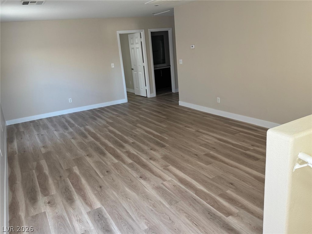 3962 Coyote Ridge Court Las Vegas, NV 89129 - Photo 23 of 35 Contemporary plank flooring unifies this open-concept room, ready for your personalized touch.