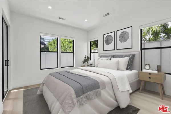 a bedroom with bed and a window