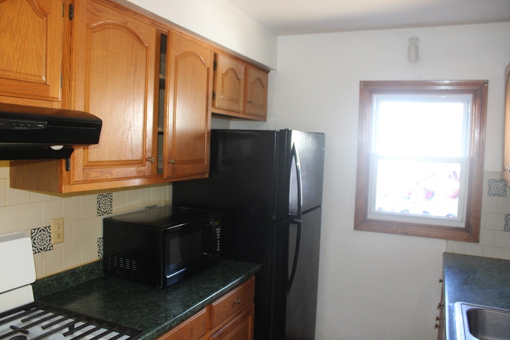 136 Horton Street, Unit 1 Fall River, MA 02723 - Photo 16 of 17 a kitchen with a refrigerator and a stove