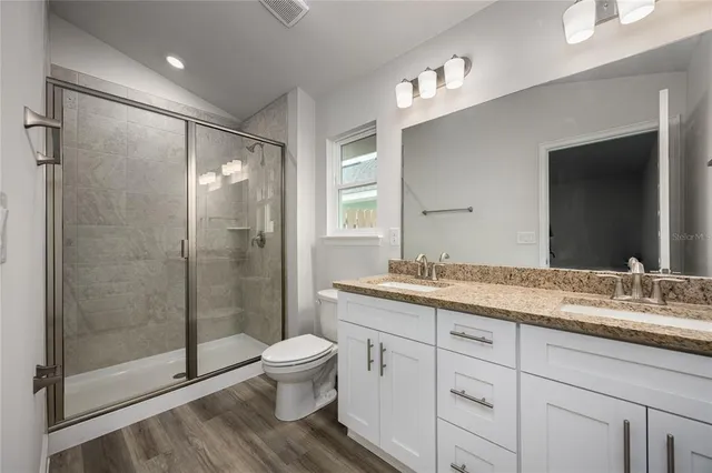 a white toilet next to a bathroom sink