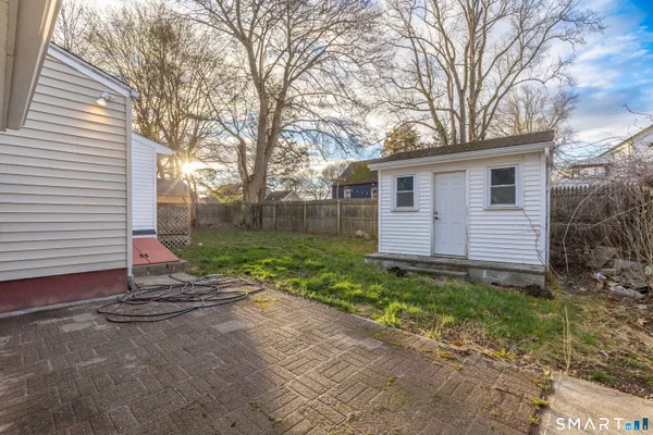a backyard of a house with plants and trees