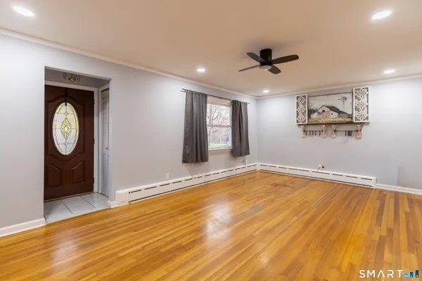 a view of empty room with wooden floor