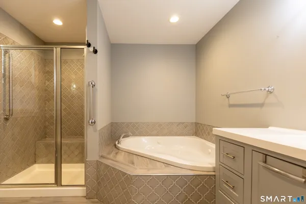 a bathroom with a tub and shower