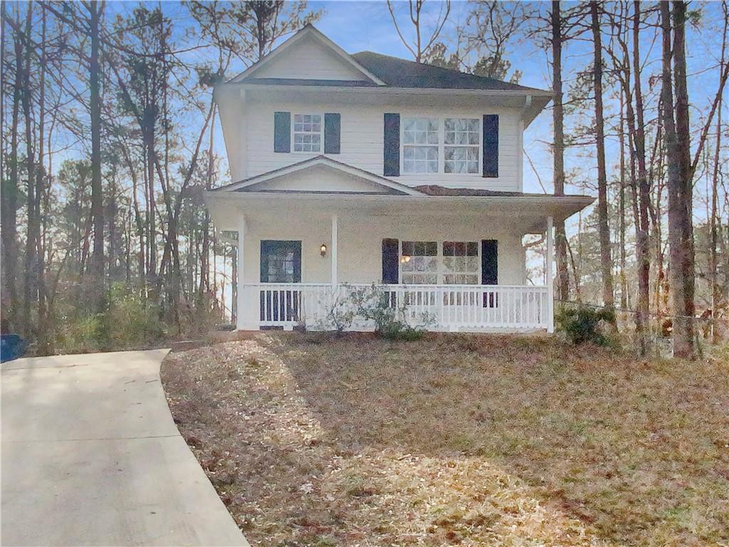 233 Southern Shores Road Jackson, GA 30233 - Photo 1 of 1 a front view of a house with a garden and trees