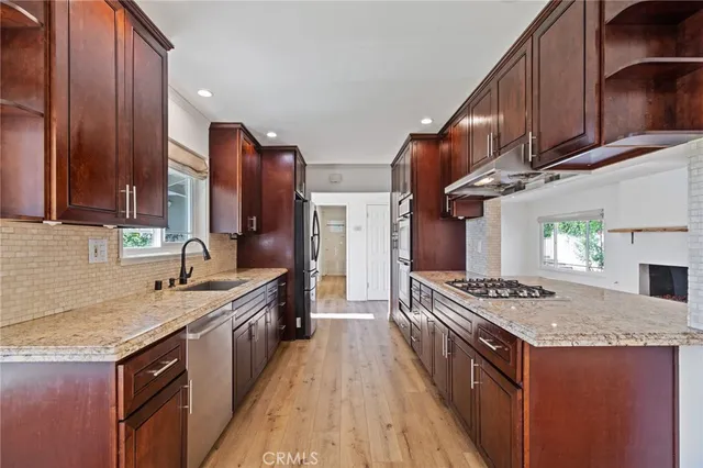 a kitchen with a sink and a wooden cabinets