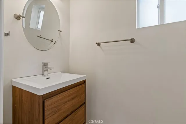 a view of a room with a sink and a chandelier fan