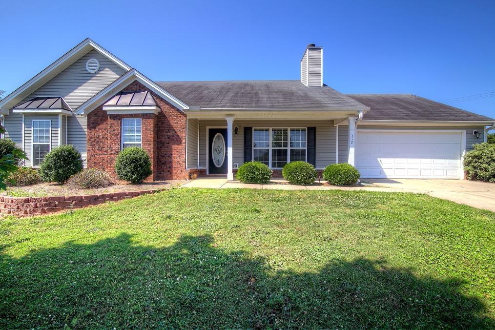 512 Silver Bell Road Jefferson, GA 30549 - Photo 1 of 1 a front view of a house with garden