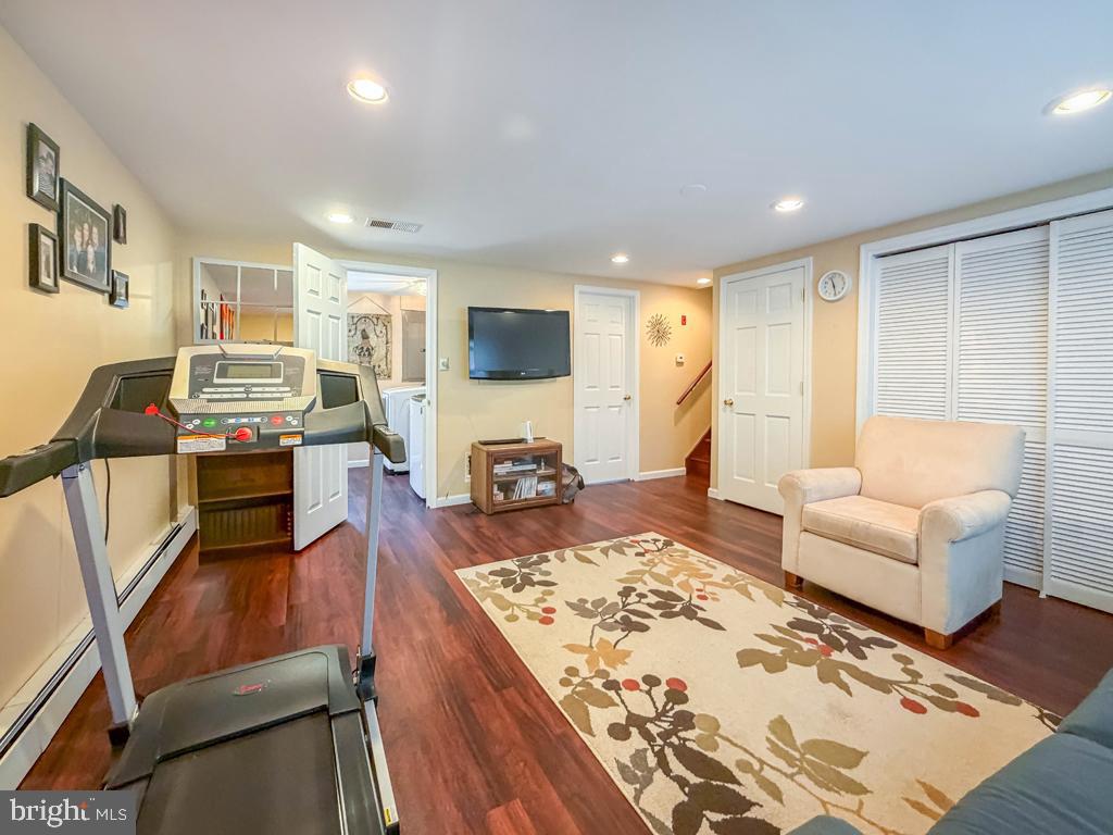925 Big Oak Road Yardley, PA 19067 - Photo 21 of 51 a living room with fireplace furniture and a flat screen tv