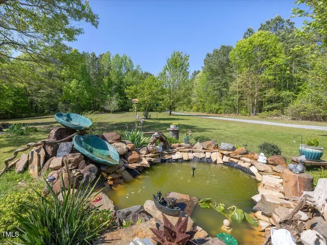 a view of a backyard with swimming pool