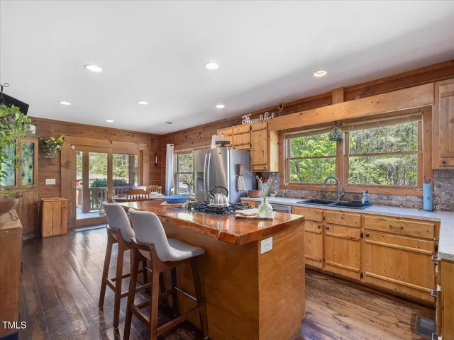 a kitchen with stainless steel appliances granite countertop a stove a sink and a refrigerator