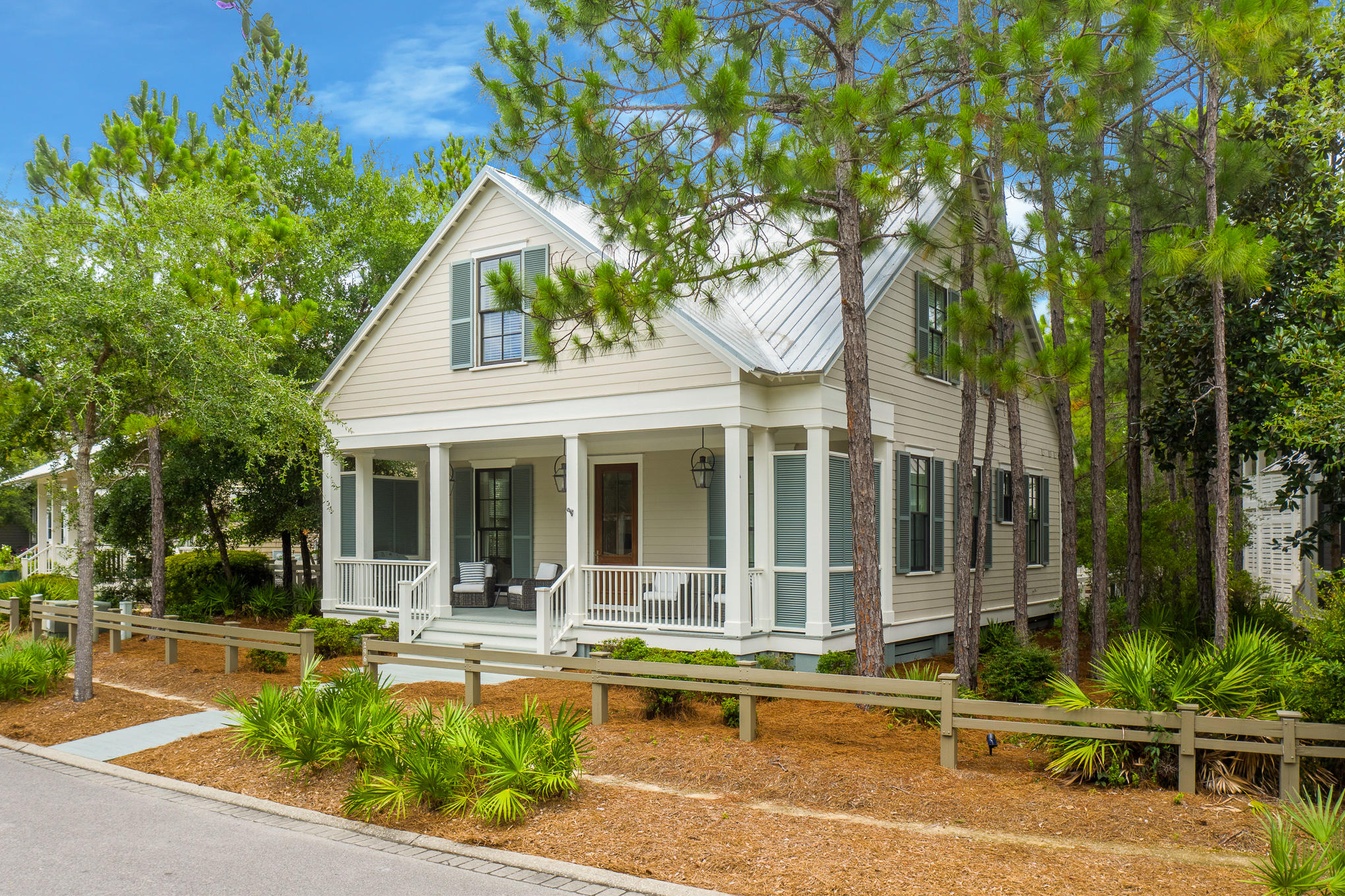 296 Pine Needle Way Santa Rosa Beach, FL 32459 - Photo 2 of 61 a view of a white house with a large pool and couches chairs under an umbrella