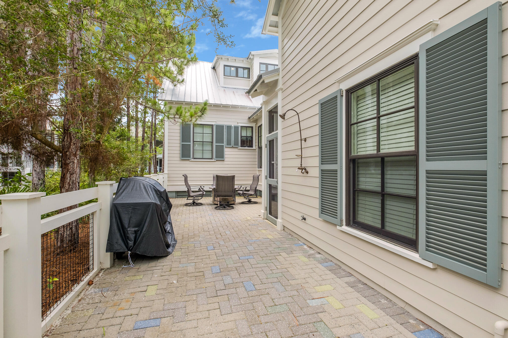 296 Pine Needle Way Santa Rosa Beach, FL 32459 - Photo 23 of 61 a view of a patio with a table and chairs and a barbeque