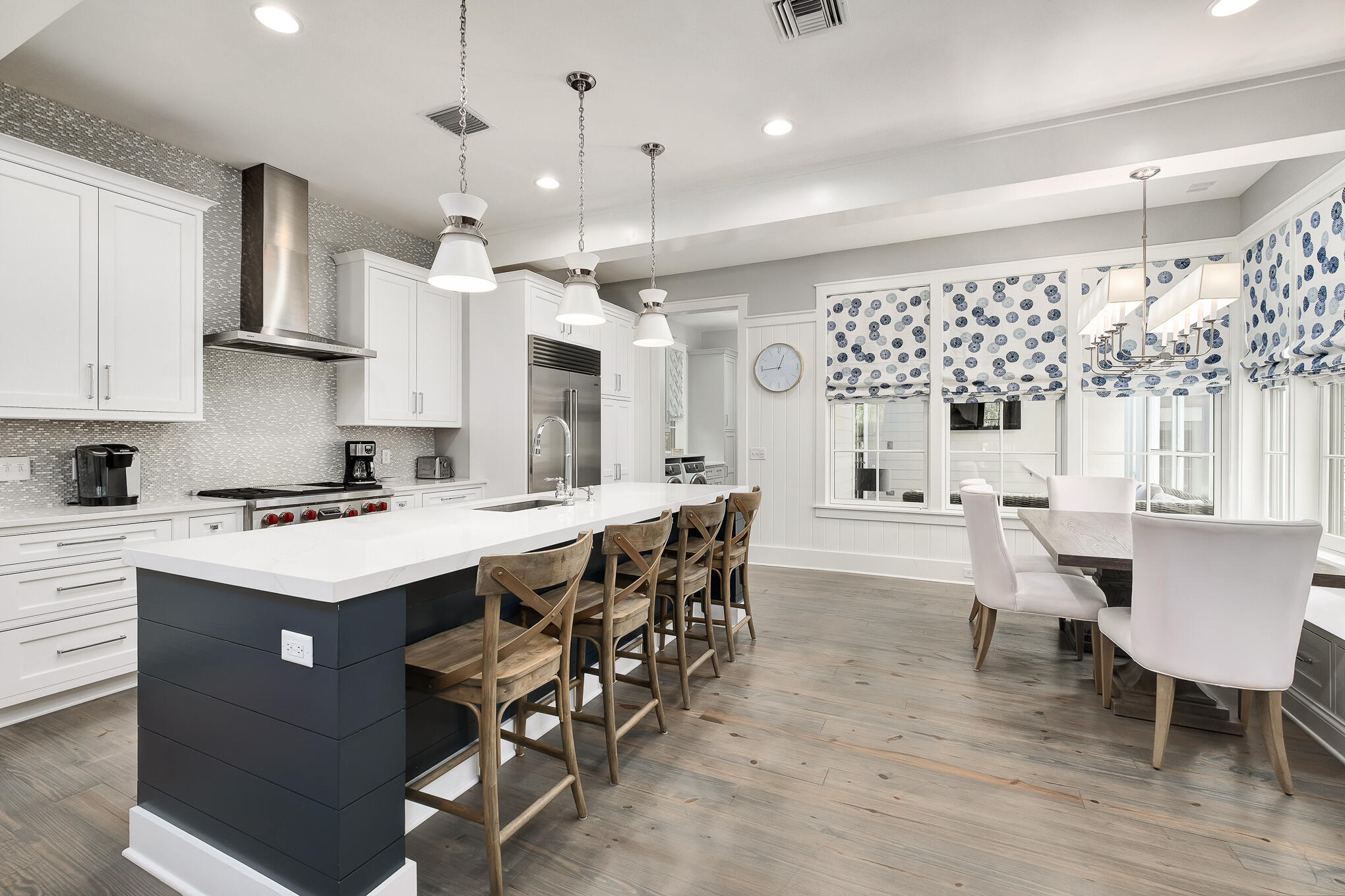 296 Pine Needle Way Santa Rosa Beach, FL 32459 - Photo 30 of 61 a kitchen with stainless steel appliances a stove a refrigerator a kitchen island with a dining table and chairs