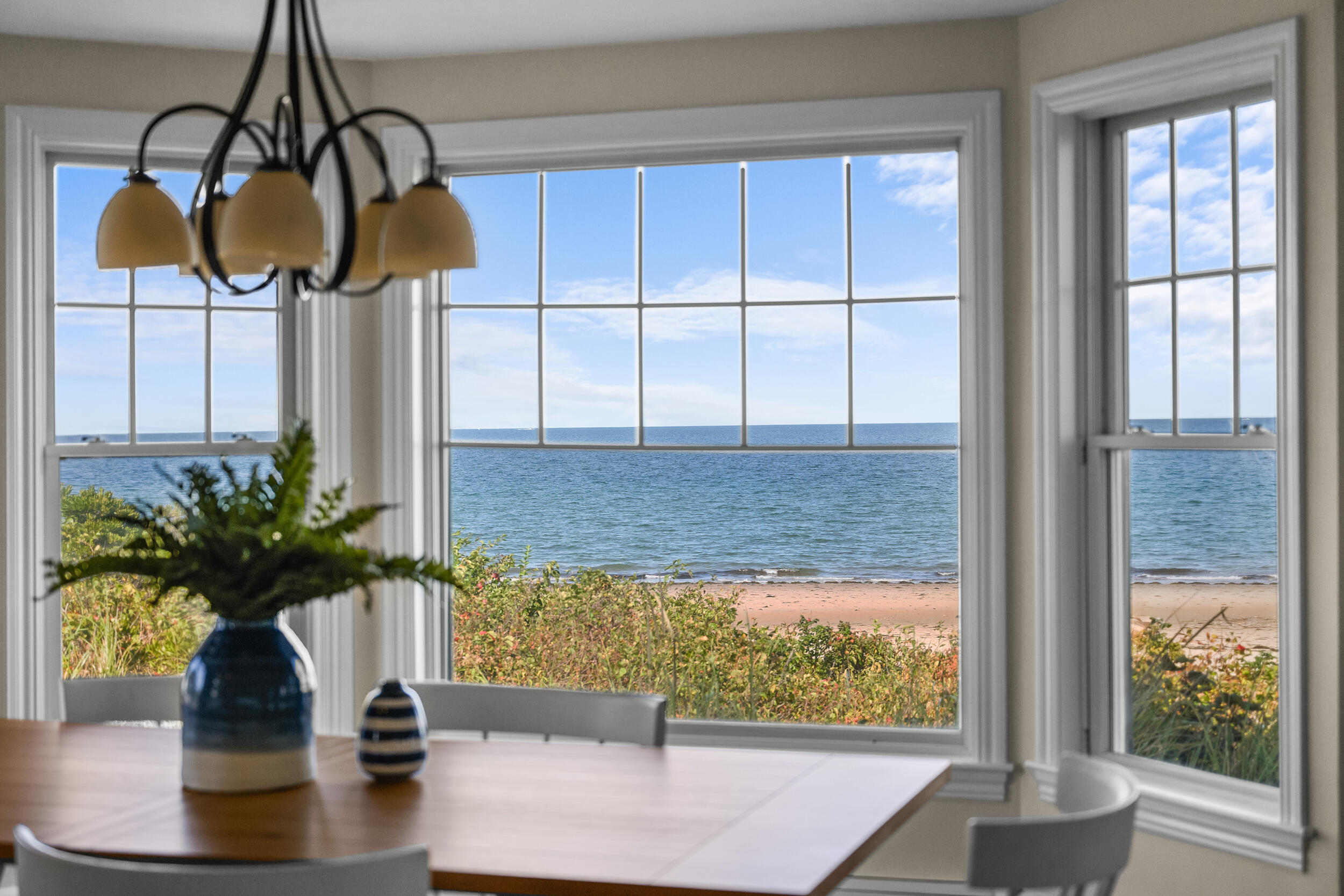 67 Phillips Road Sagamore Beach, MA 02562 - Photo 12 of 43 a vase of flowers sitting on a table with window