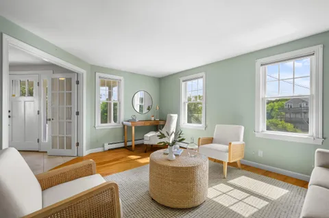 a living room with furniture a window and a table