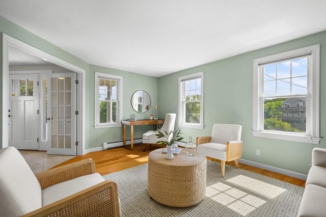 a living room with furniture a window and a table