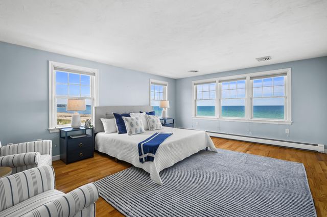 a bedroom with a bed and a large window