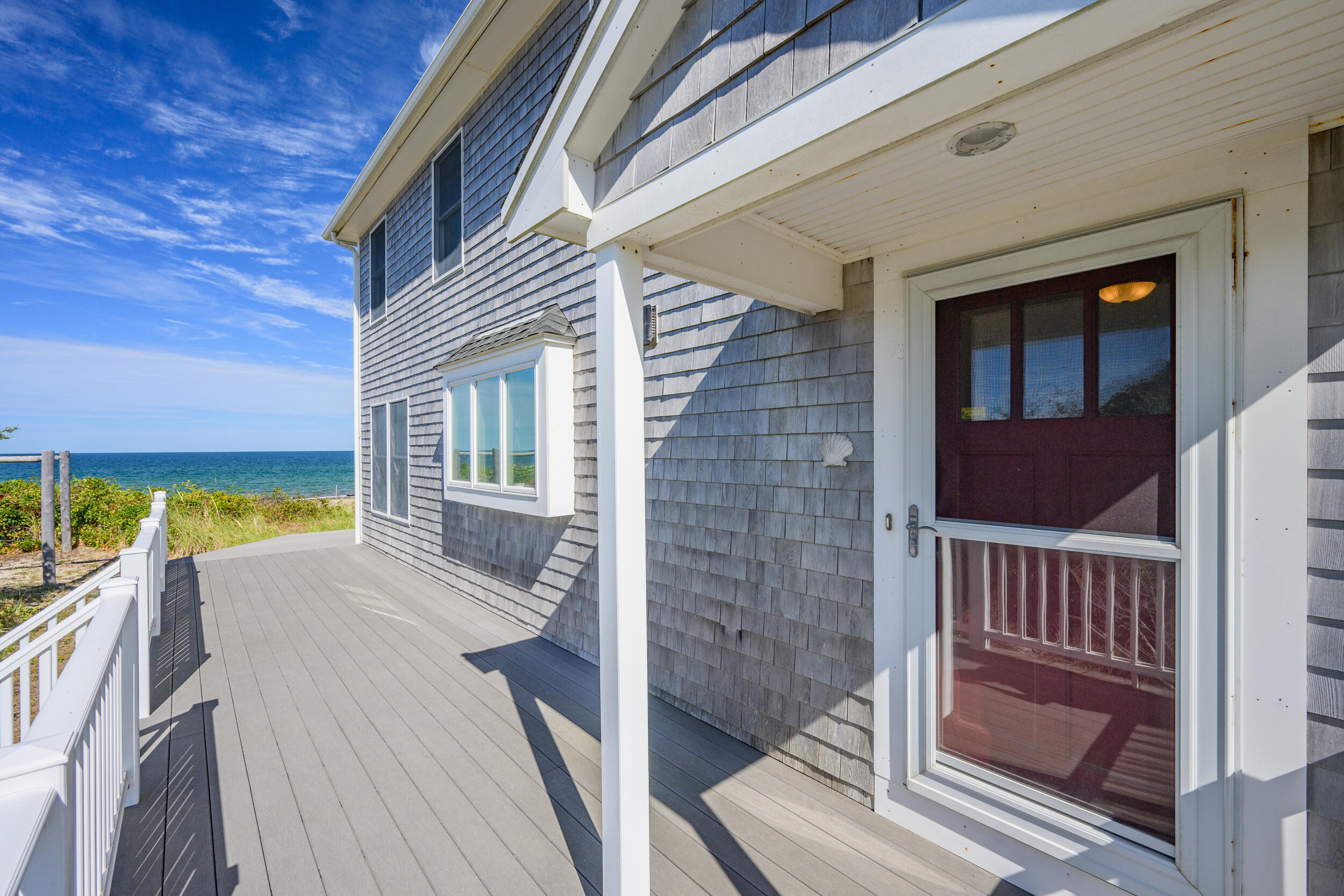 67 Phillips Road Sagamore Beach, MA 02562 - Photo 31 of 43 a view of balcony with two chairs and wooden floor