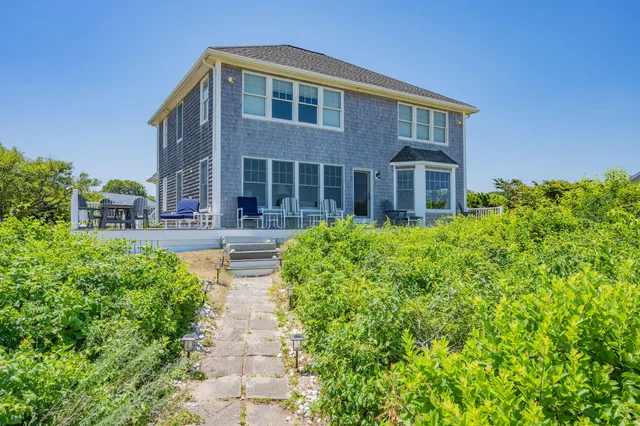 a front view of house with yard and green space