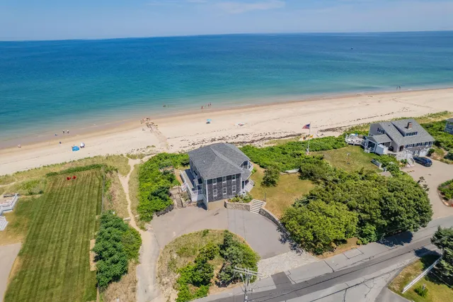 an aerial view of a house with a yard