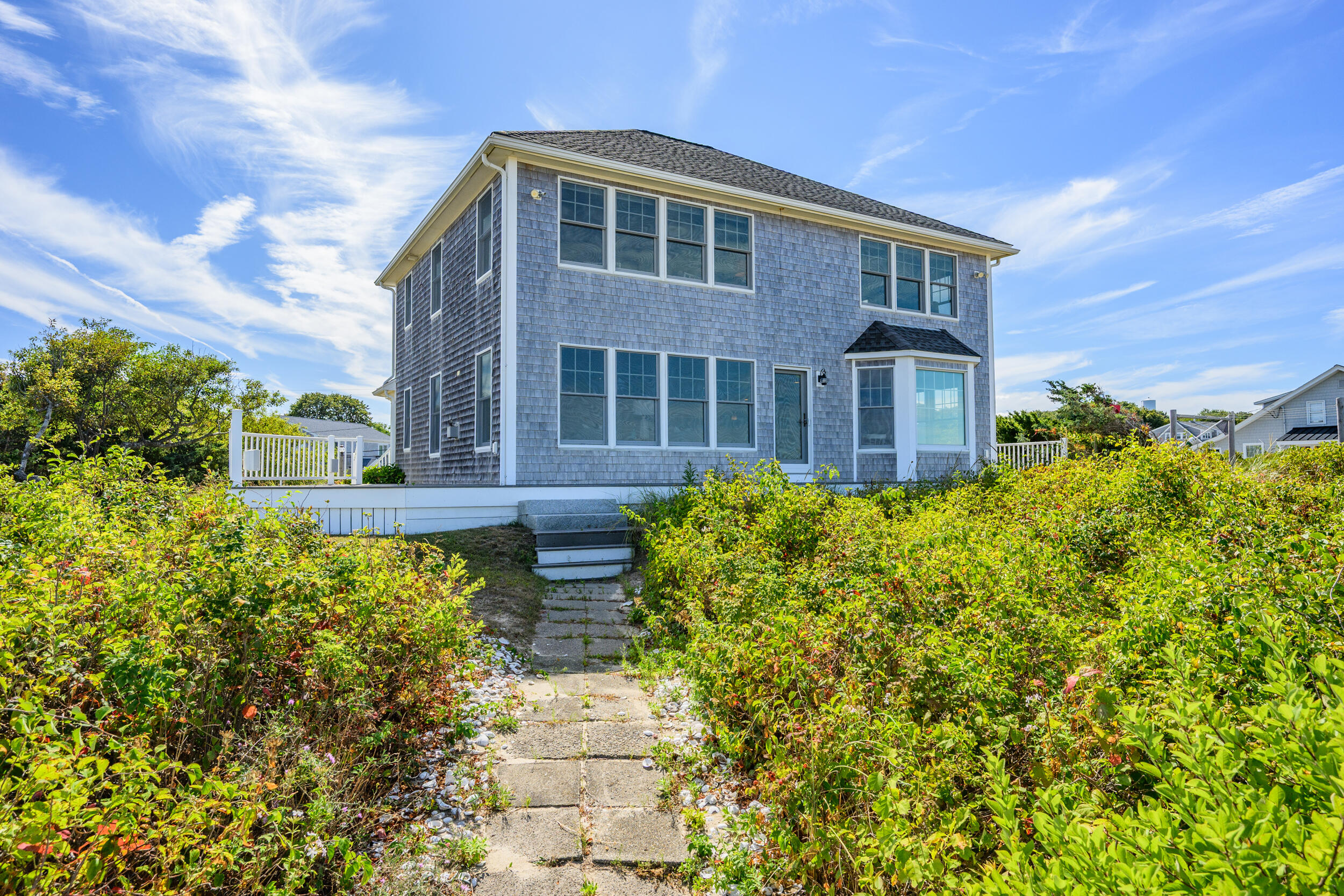 67 Phillips Road Sagamore Beach, MA 02562 - Photo 4 of 43 a front view of a house with a yard