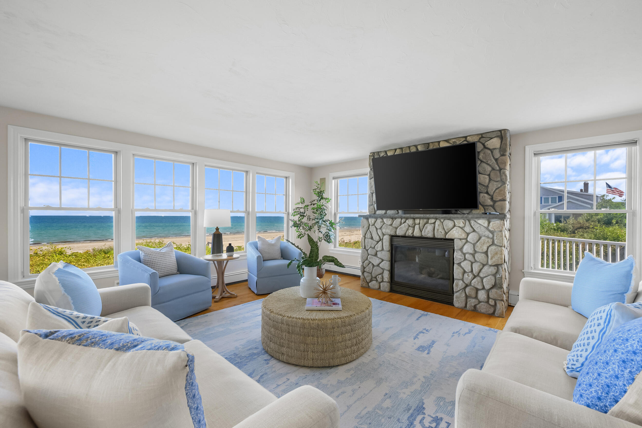 67 Phillips Road Sagamore Beach, MA 02562 - Photo 8 of 43 a living room with furniture a fireplace and a flat screen tv