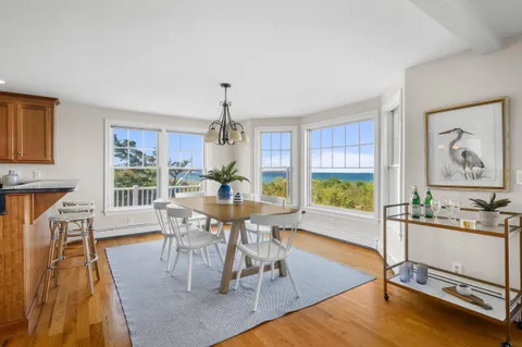 a view of a dining room with furniture window and wooden floor