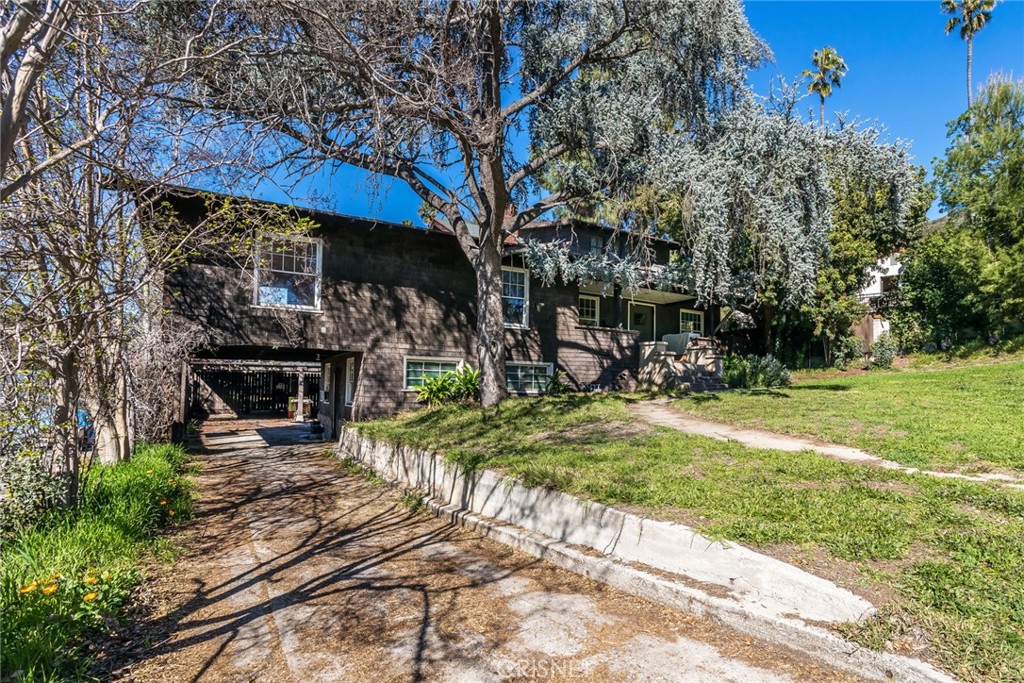 a view of a chairs and table in the backyard