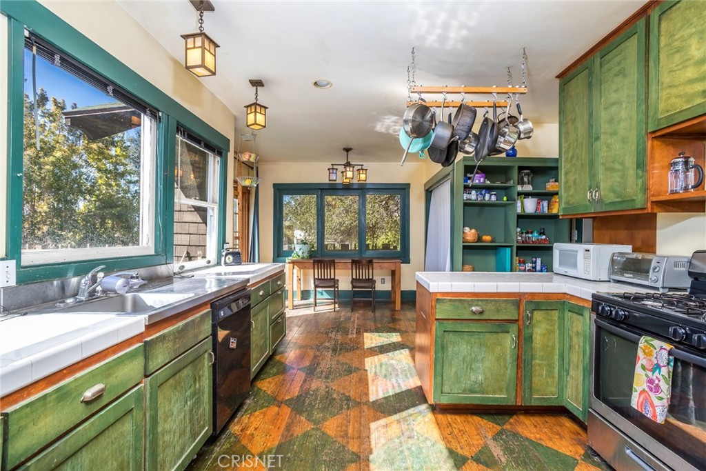 5289 Ellenwood Drive Eagle Rock, CA 90041 - Photo 11 of 28 a large kitchen with stainless steel appliances granite countertop a sink and cabinets