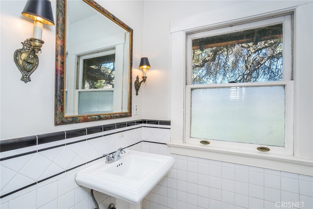 5289 Ellenwood Drive Eagle Rock, CA 90041 - Photo 23 of 28 a bathroom with a sink and a mirror
